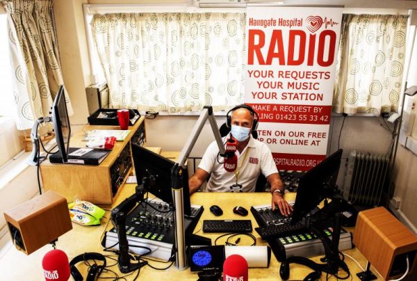 A cupboard under the stairs and a weekly sing-along podcast: just some of the innovative solutions that Hospital Radio volunteers across the country have found to continue broadcasting during the Covid-19 pandemic.